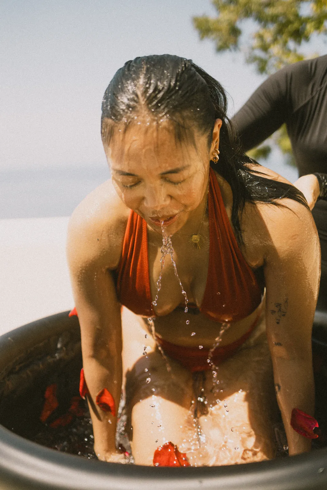 Guest rising out of the ice bath, water streaming down