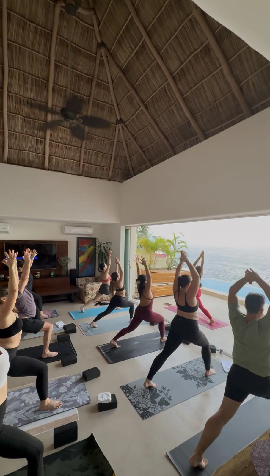 Yoga flow under the palapa roof with ocean views