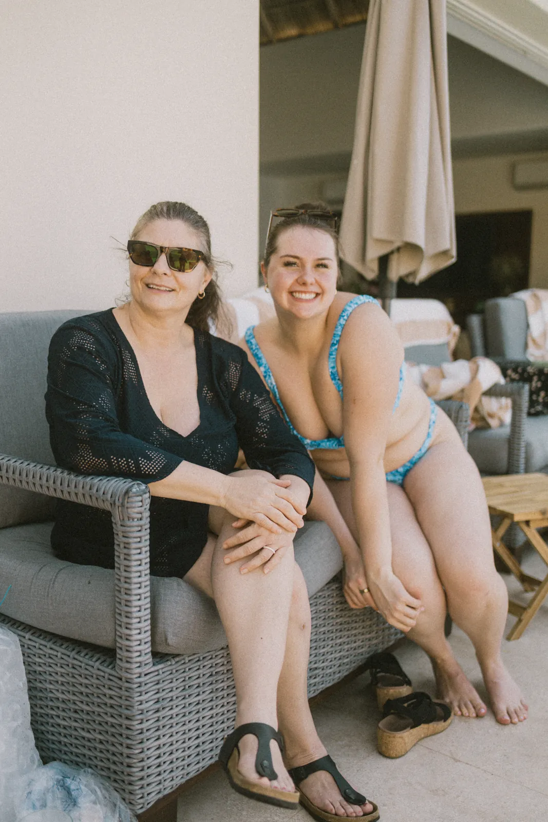 Two guests smiling together on the patio